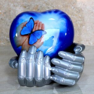 eSplanade Metal Heart-shaped Urn in Hands Stand Cremation Memorial Jar Pot Container | Medium Size Urn for Funeral Ashes Burial | Butterfly Printed Urn | Blue - 6" Inches